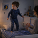 A young child lying awake at bedtime, having a hard time falling asleep