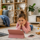 A young girl absorbed in screens, the everyday habit a screen-free gift gently offers a break from