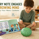 A child playing a steel tongue drum with a songbook, showing how every note engages a growing mind