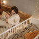 A father reading a bedtime story to his young child in a warmly lit bedroom